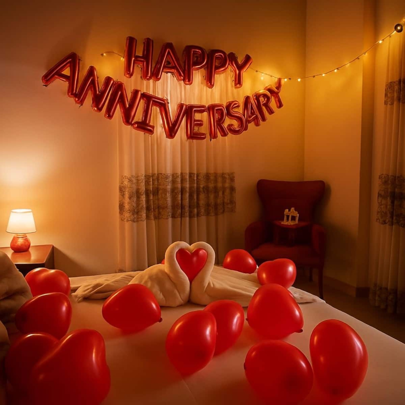 Bedroom decorated with red balloons for an anniversary