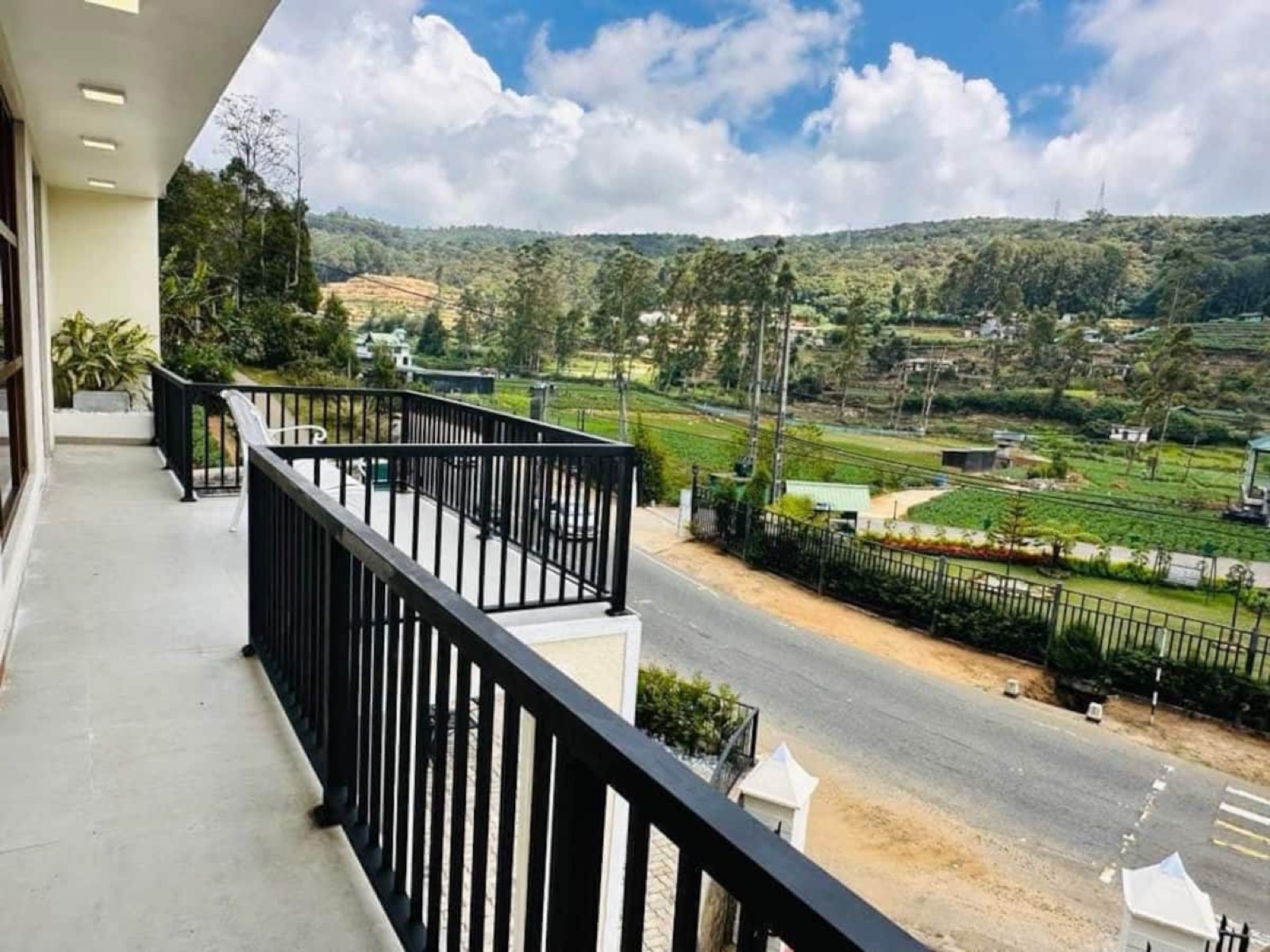 Balcony overlooking green fields and hills